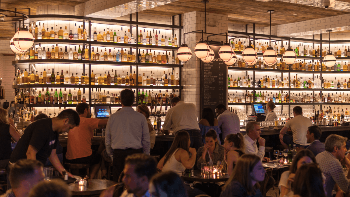 People hanging out inside of a bar